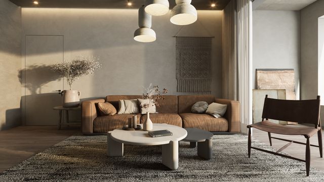 Modern living room styled with a brown sofa, round coffee table, textured rug, and hanging pendant lamps.